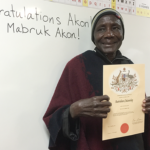 Akon holding Australian Citizenship certificate