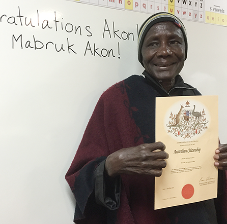 Akon holding Australian Citizenship certificate